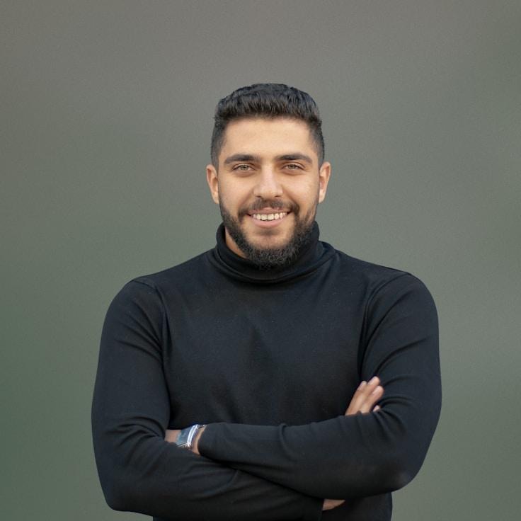 Avery Kim, Lead Design Curator at Stem & Story Studio, reviewing corporate floral arrangements